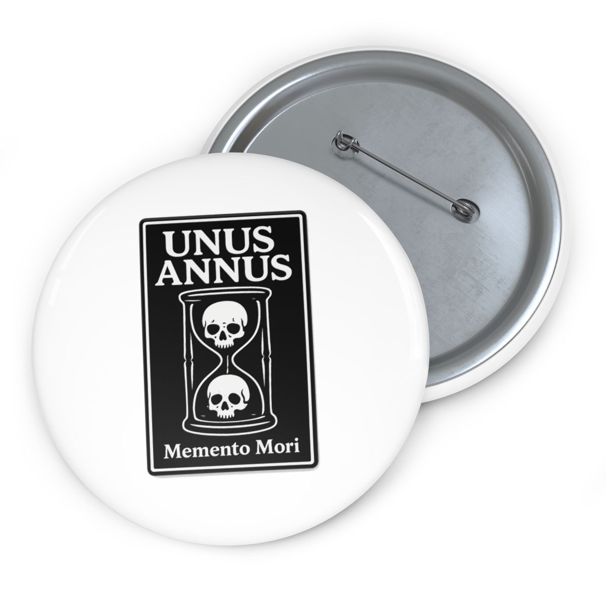 A black and white enamel pin featuring an hourglass with two skulls inside. The pin is on a brown card with the words "Unus Annus" and "Memento Mori" printed on it. - alternate angle 2, merchandise